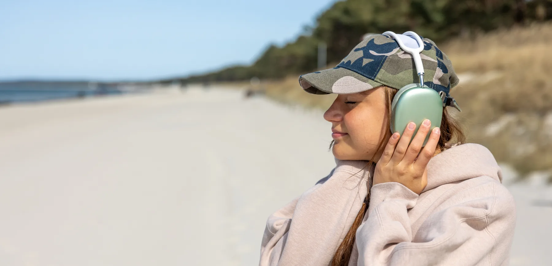 Traveler listening to headphones on the shore